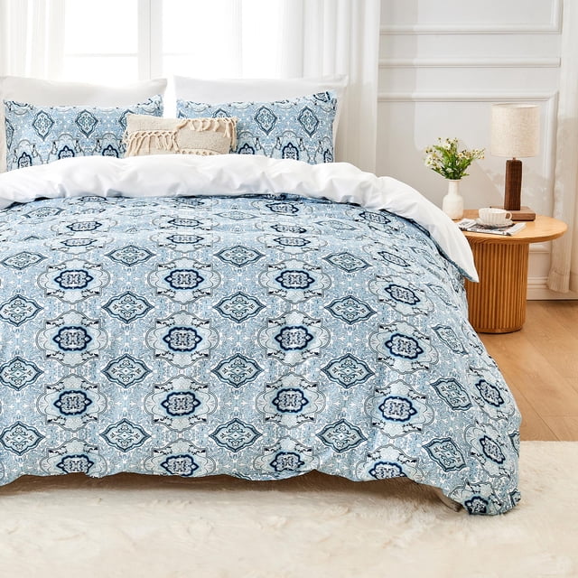 Hitime Queen Duvet Cover Set, a 3-piece bedding set featuring a soft and breathable microfiber material with a fantasy-inspired watercolor pattern. The set includes one queen-size duvet cover and two matching pillowcases, designed with a zipper closure for convenience. The duvet cover showcases a blue and white intricate geometric design, adding elegance to the bedroom decor. Displayed in a bright, minimalist bedroom setting with a wooden side table and decorative accents.