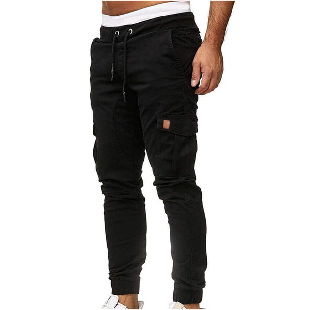 Pantalon de Jogging pour Hommes avec Poches en Noir Uni, Conçu pour un Usage Décontracté et Extérieur. Ces Pantalons de Jogging Légers en polyester Style cargo Comprennent Plusieurs Poches, une Taille Élastique avec Cordon de Serrage et des Chevilles Côtelées. Idéal pour les Hommes à la Recherche d'Un Confort Mode Été et Printemps, Y Compris les Pantalons cargo pour Hommes et les joggers de sport.