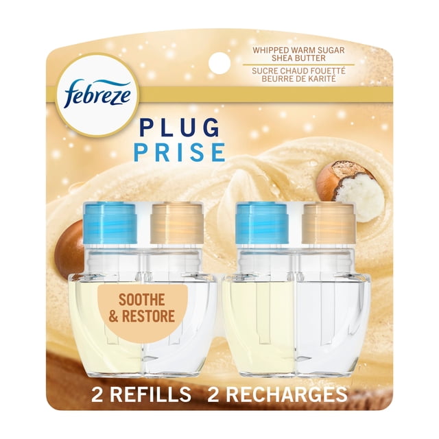 Febreze Plug In Air Freshener Soothe & Restore scented oil refill pack with two clear dual-chamber bottles featuring blue and beige caps, displayed on a beige background with whipped warm sugar and shea butter imagery, designed for continuous odor-fighting freshness.