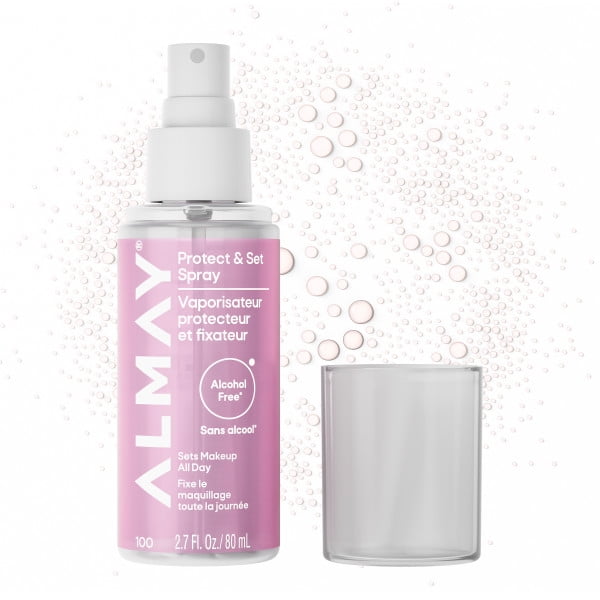Almay Protect And Set Spray in an 80 ml clear bottle with white spray nozzle and pink label, alcohol-free formula that locks makeup all day and hydrates skin, shown with a clear cap and water droplets background, ideal for makeup setting and skin protection.