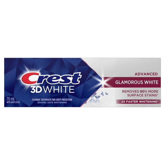 Crest 3D White Advanced Glamorous White Teeth Whitening Toothpaste 70 ml box with blue geometric design and white panel, highlighting cavity protection, enamel safe whitening, removal of 90% more surface stains, and 2X faster whitening for a bright smile.