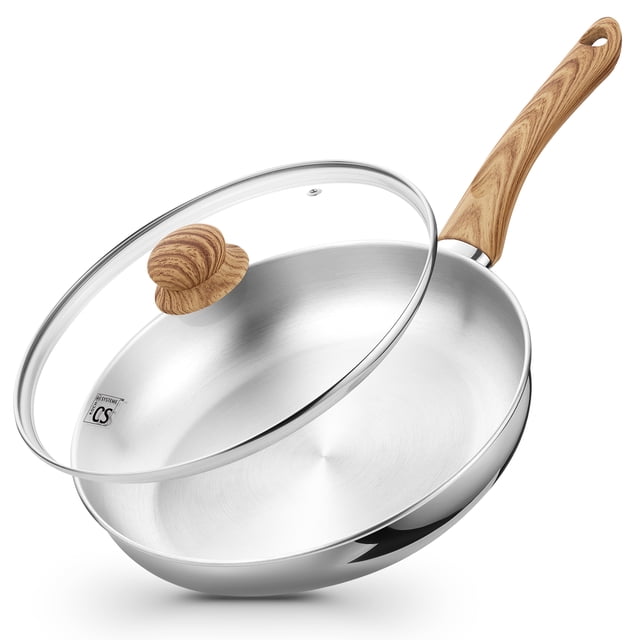 Koch Systeme CS 10 Inch Stainless Steel Frying Pan with Bakelite Handle, featuring a polished stainless steel body and a wood-grain Bakelite handle for a comfortable grip. The pan includes a clear glass lid with a matching wood-grain knob. Designed for fast and even heating with an aluminum core, it is compatible with induction, gas, electric, and ceramic cooktops and oven safe up to 424°F. Dishwasher safe for easy cleaning, with flared rims for drip-free pouring.