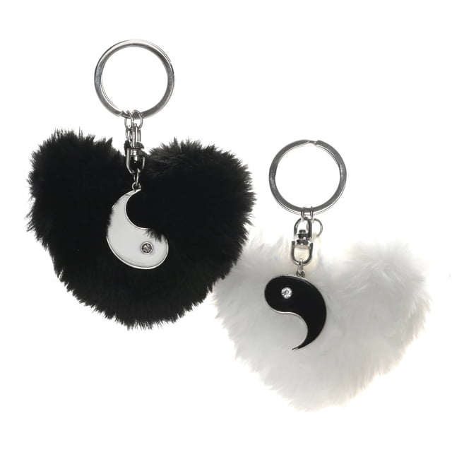 Claire's Silver Pom Pom Yin Yang Best Friends Keychains set featuring two keyrings, each with a fluffy pom pom in black or white and a coordinating yin yang half charm. Perfect for holding keys or trinkets, this travel accessory is a thoughtful gift for adults, teens, and tweens for special occasions.