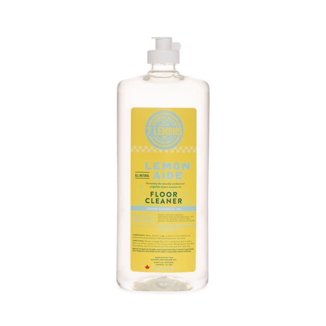 Lemon Aide Floor Cleaner in a clear plastic bottle with a white pump dispenser, featuring a yellow label that highlights its natural lemon essential oil formula, biodegradable and septic safe, suitable for wood, ceramic, and stone floors, and safe for children and pets.