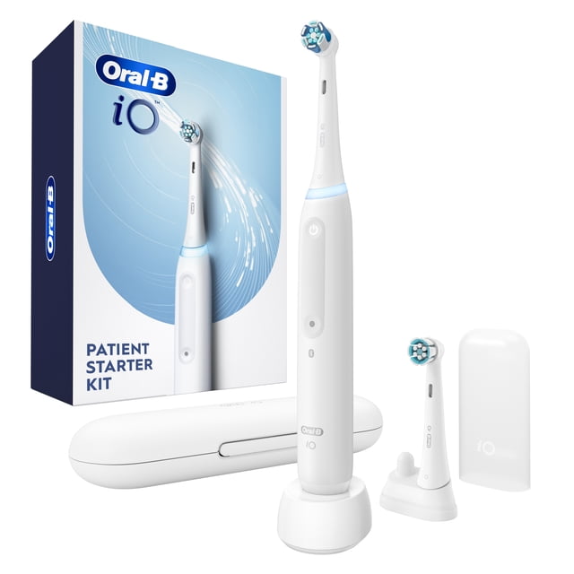 Oral-B iO Electric Toothbrush Patient Starter Kit in white, including an electric toothbrush with a round brush head and blue bristles, charging stand, extra brush head, and travel case with packaging. Features clinically proven plaque removal, pressure sensor, and 2-minute timer for effective oral care.