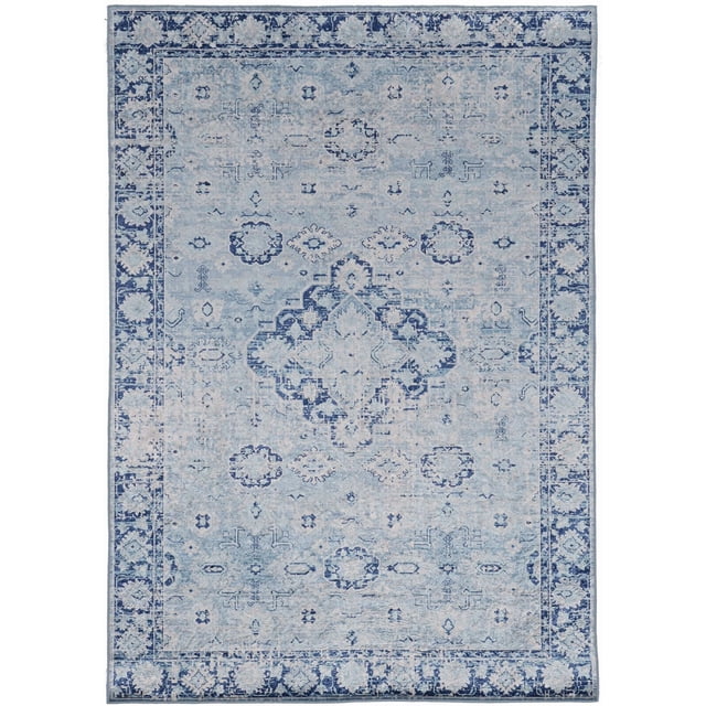 Emerald Kramer Ivory & Blue 6'7" x 9'7" area rug made of low pile polyester with a traditional pale blue and navy pattern featuring a central medallion and floral geometric motifs. It has a navy floral border with serged edges, a silky finish, and a rubber-backed grip ideal for high traffic and larger rooms. Suitable for defining open concept spaces and easy to maintain with vacuuming and spot cleaning.