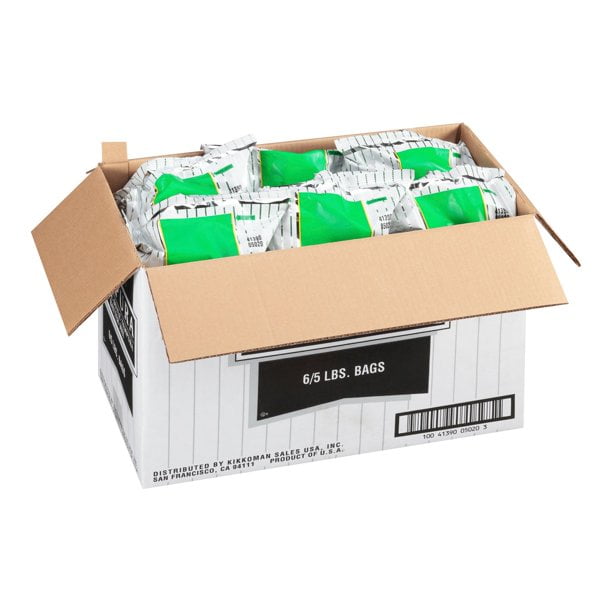 Kikkoman Japanese Style Tempura Batter Mix 5 lb. Bag - 6/Case shown in an open cardboard box containing six green and white packaged bags. This authentic Japanese-style batter mix is perfect for creating crispy coatings for seafood, vegetables, and fried foods. Ideal for Asian-inspired restaurants and food service establishments.