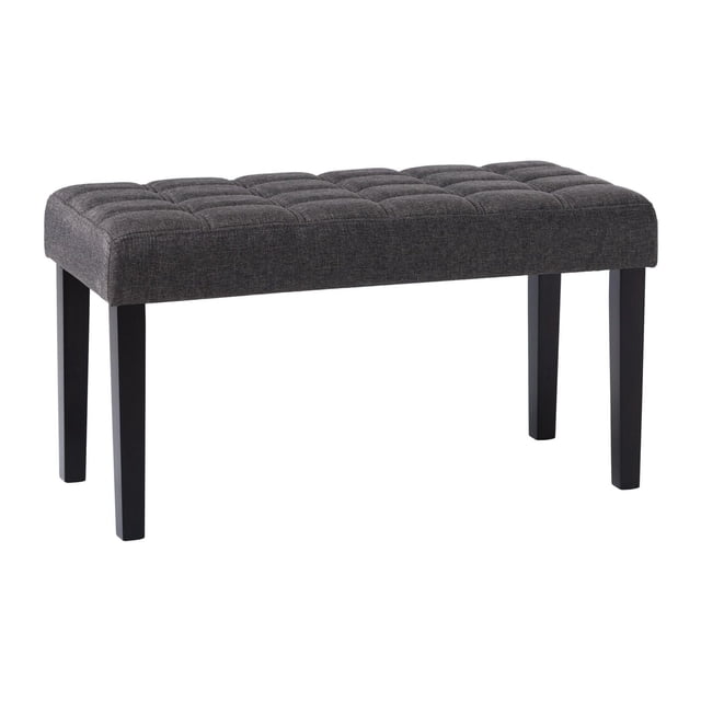 CorLiving California Fabric Upholstered and Tufted Entryway Accent Bench with Wood Legs in dark grey polyester fabric, featuring a foam-padded tufted seat with topstitching and dark stained wood legs, shown in a front 3/4 view on a white background, ideal for entryways or as extra seating in small spaces.