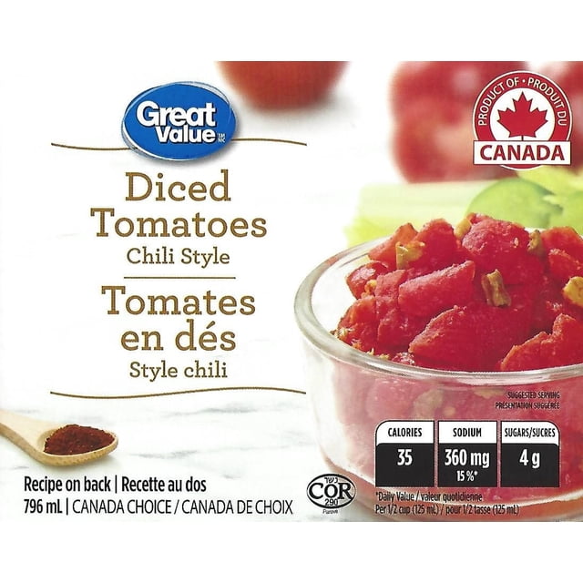 Great Value Chili Style Diced Tomatoes in a clear glass bowl showing red diced tomatoes with green chili pieces on a white surface, accompanied by a wooden spoon with chili powder and nutrition facts, product of Canada, suitable for chili, soups, and sauces.