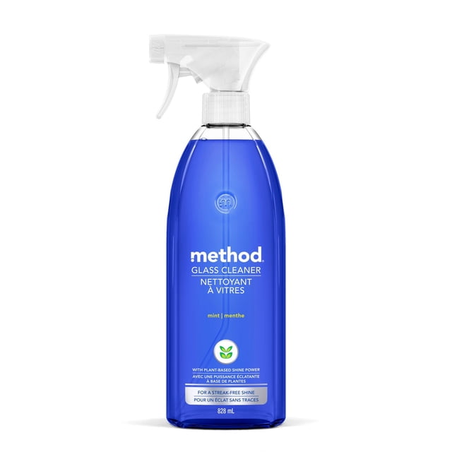Method Glass Cleaner Spray, Mint, 828 mL, blue translucent plastic bottle with white spray trigger, plant-based household cleaner for streak-free shine on glass surfaces like windows and mirrors, labelled in English and French.