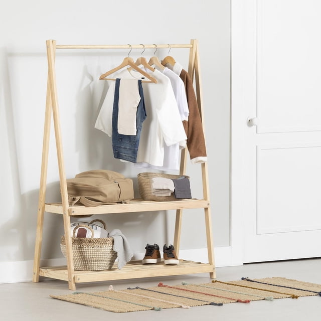 South Shore Furniture Sweedi Wooden Clothes Rack with Storage Shelves for Kids in natural pine wood finish, featuring two open shelves supporting shoes and baskets, and a hanging bar with children's clothes, designed for ages 7 to 12 to promote independence with Scandinavian minimalist style.