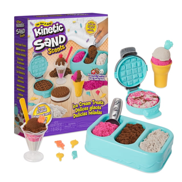 Kinetic Sand Scents Ice Cream Treats Playset with three scented kinetic sand colors—strawberry pink, chocolate brown, and vanilla white—in a blue freezer-style tray with three compartments and a silver scoop, a blue waffle press, an ice cream cone mold with layered pink and white sand, a clear sundae cup with layered sand and a yellow spoon, plus six colorful topping accessories, suitable for sensory play and creative arts and crafts for kids aged 3 and up.