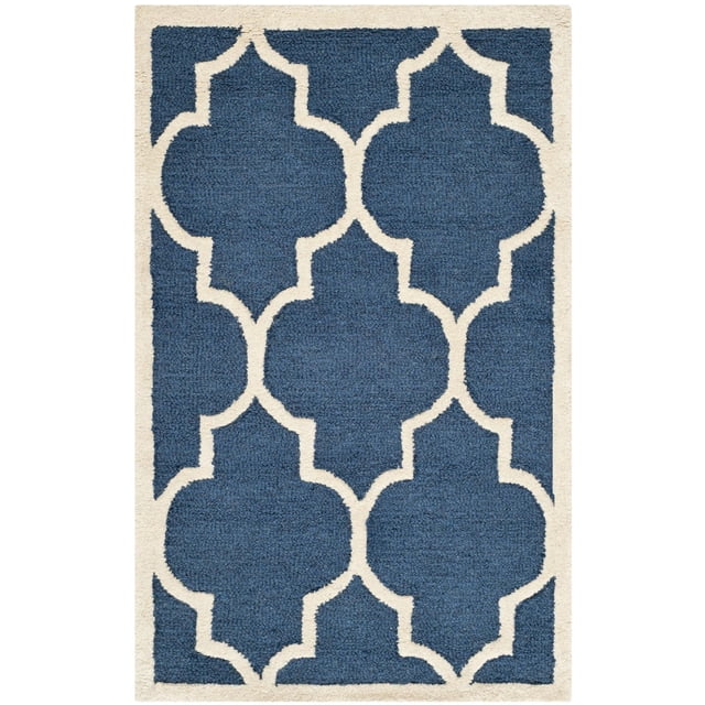 Safavieh Cambridge Kevin Geometric Area Rug with hand-tufted wool construction, featuring a blue background and off-white geometric trellis pattern in plush cut and high/low loop piles, ideal for home or office accent areas and often used to define seating zones.