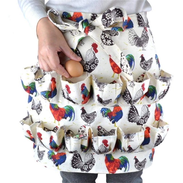Biinggo Egg Collecting Apron, waterproof and made of polyester cotton, featuring 12 egg pockets. The apron has a colourful rooster print design and an adjustable belt for adults and children. It is shown being worn, with one egg being placed into a pocket. Ideal for collecting eggs, duck eggs, or small farm items.