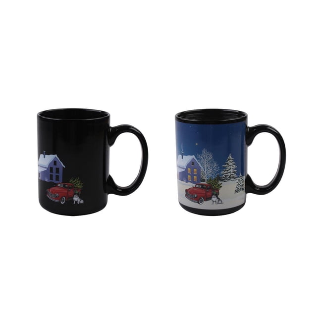 Holiday Time 15 oz Ceramic Heat Active Change Mug - Red Truck, 1 Piece, showing two black ceramic mugs side by side; one with a red truck, Christmas tree, and snowman in front of a snowy house on a black background, the other revealing a full winter night scene with snow-covered house, trees, and stars on a blue background activated by hot liquid. Ideal for coffee, hot chocolate, or warm beverages.