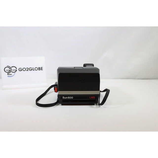 Polaroid Sun 600 LMS – Classic Instant Film Camera with Auto Exposure, displayed in a front-facing view. The camera has a black body with a retro aesthetic, a red shutter button, and an attached strap. It uses Polaroid 600 film and features a Light Management System (LMS) for auto exposure and a built-in flash for clear photos in low light. The item is used, showing minor cosmetic wear but fully operational.
