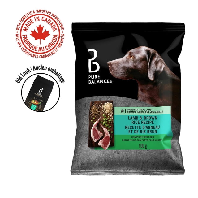 Pure Balance Lamb & Brown Rice Recipe Dry Dog Food 100g bag with black and grey packaging featuring a brown dog profile, a turquoise label highlighting real lamb as the first ingredient, and images of lamb meat, brown rice, peas, and spices, with bilingual English and French text and a Made in Canada mark.