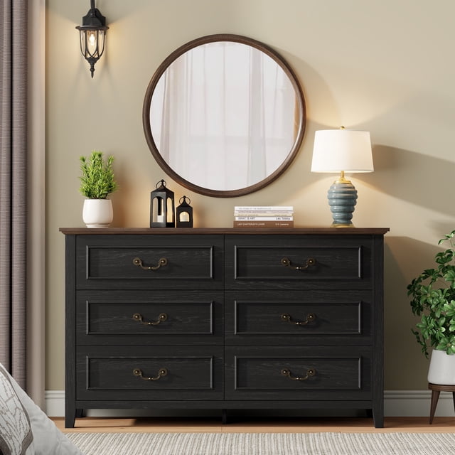 GIKPAL Black Dresser for Bedroom, a 6-drawer storage cabinet with antique bronze handles and a farmhouse rustic design. Crafted from MDF wood with a distressed oak black finish, it measures 47.24 inches wide, 15.75 inches deep, and 29.13 inches high. Styled in a cozy room with a round mirror, table lamp, and decorative accents, this versatile entryway furniture is ideal for bedrooms, living rooms, or hallways.