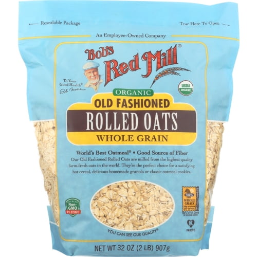 Bob's Red Mill Flocons d'Avoine Biologiques à l'Ancienne, Grains Entiers, 32 oz (907 g) Emballage Refermable. l'Avant du Sac Affiche le logo de la Marque, le Nom du Produit et des certifications Telles Que le Projet Biologique de l'USDA et non-OGM Vérifié. les Flocons d'Avoine Sont Visibles à Travers une section Transparente au Bas de l'Emballage Bleu.
