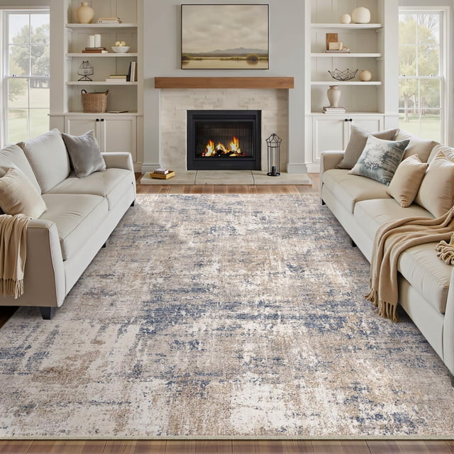 BERTHMEER 5'x7' Modern Abstract Area Rug in blue with a distressed pattern, shown in a living room with neutral sofas and a fireplace. Made of polyester and thermoplastic rubber, this low-pile, non-slip rug is machine washable and ideal for living rooms, bedrooms, dining rooms, and offices.