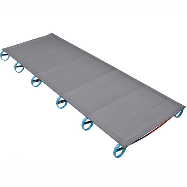 CAROOTU Ultralight Camping Cot Portable Folding Compact Easy Set Up Tent Camping Cot Bed for Outdoor Travel. This grey camping cot features a foldable aluminum shock-cord pole structure for quick assembly and disassembly. It measures 180x60x12cm and is supported by blue circular legs. Ideal for camping, hiking, and indoor use, it offers off-ground comfort, protecting users from uneven surfaces and insects.