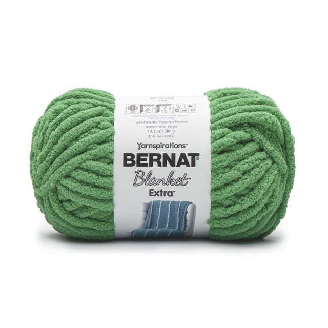 Bernat® Blanket Extra™ Yarn in green, jumbo #7 polyester chenille yarn weighing 10.5 oz (300 g) and measuring 97 yards, shown front-facing with a white label featuring black text and an image of a blue knitted blanket, ideal for soft, quick home accents and machine washable projects.