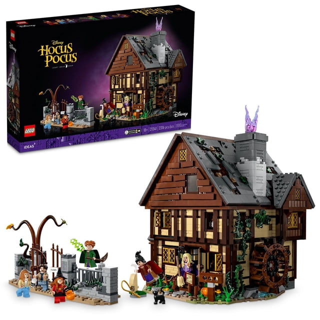LEGO Ideas Disney Hocus Pocus: The Sanderson Sisters' Cottage building set featuring a detailed brown and tan cottage with a grey roof, chimney with purple translucent flames, and a water wheel. Includes six minifigures, a black cat figure, a graveyard gate with twisted tree, and accessories like a broom, pumpkin bucket, and green lightning spell, suitable for fans of fantasy and Halloween themes.