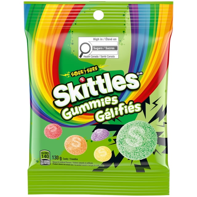 SKITTLES Sour Gummies Chewy Candy 130g bag with green background and rainbow design. The front shows five sugar-coated sour gummies in red, orange, yellow, purple, and green representing strawberry, green apple, lemon, orange, and grape flavours. Includes Health Canada sugar warning and calorie info. Suitable for on-the-go snacking or family treats.