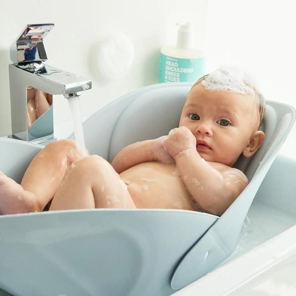Frida Baby - Soft Sink Baby Bath - Easy To Clean Baby Bathtub + Bath Cushion That Supports Baby's Head - Quick Dry Material - Machine Washable