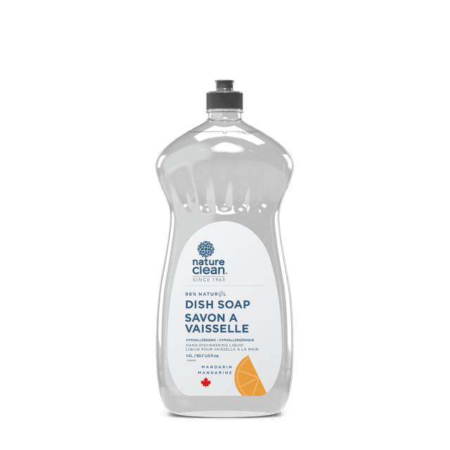 Nature Clean Dishwashing Liquid Mandarin Grapefruit 1.5L front-facing plastic bottle with pump; translucent amber-orange liquid, white label with Nature Clean name and mandarin and grapefruit illustration and '1.5L' volume. Label states 98% naturally derived, concentrate scented with essential oils, hypoallergenic and dermatologist tested. Placed on a kitchen counter by a stainless steel sink; often used for hand-washing dishes or soaking utensils.