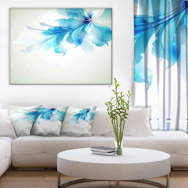Design Art Tender Blue Abstract Flowers Canvas Print gallery wrapped on a 1-inch wood sub frame, featuring soft blue abstract floral shapes on a white background, displayed above a white sectional sofa with matching blue floral accent pillows in a modern living room with a round white coffee table and a glass vase with green bamboo stalks, ideal for coordinated home décor.