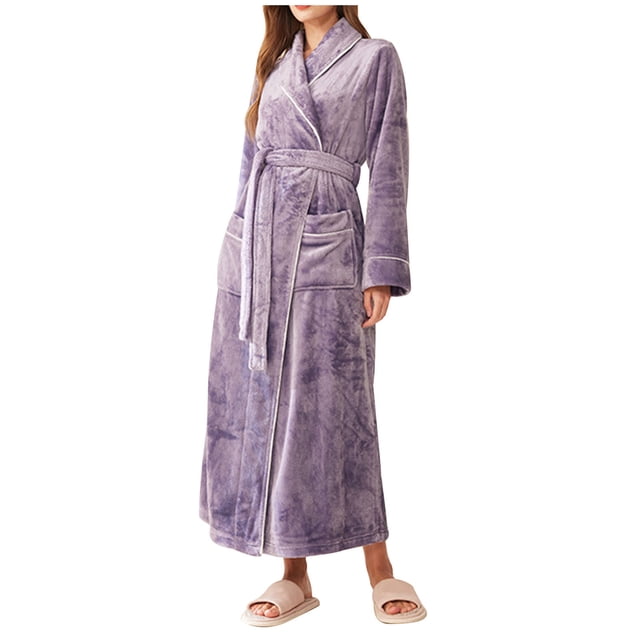 Timegard Womens Bathrobe Long Sleeve Lapel Neck Nightgowns Long Plush Robes Fall Winter Warm Comfy Robe. A full-length, long-sleeve plush robe in a soft lavender tone, featuring a lapel neckline, a belted waist, and two front pockets. Crafted from lightweight, breathable, and cozy fabric, perfect for lounging or sleeping during colder seasons. Displayed on a model paired with slippers.