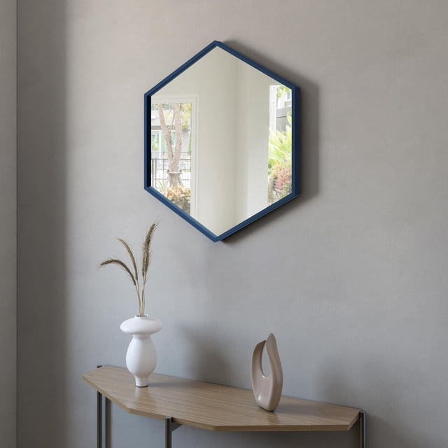 A&E Bath and Shower DELTA-BU Miroir avec un Cadre Décoratif hexagonal Bleu Monté sur un Mur Gris au-Dessus d'Une table console en Bois Tenant un vase Blanc avec des Herbes Séchées et une sculpture Abstraite beige, Réfléchissant une Fenêtre avec de la Verdure Extérieure, Convient à la Décoration de Salle de Bain Ou d'Espace de Vie.