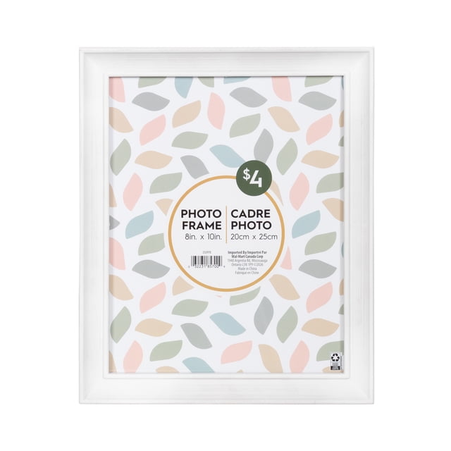 DesignOvation Nikolai 8" x 10" White Picture Frame with a curved profile, holding a placeholder sheet with pastel leaf patterns and bilingual size text in inches and centimeters, priced at $4, ready for vertical or horizontal wall or tabletop display, ideal for personalized photo arrangements.