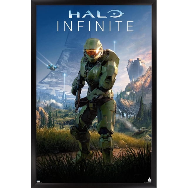 Halo Infinite - Primary Vertical Wall Poster, 22.375" x 34" featuring a centered front view of Master Chief in green armor holding a rifle, set against a detailed mountainous landscape with futuristic structures and flying vehicles under a blue sky, framed in black. This lightweight Trends International framed poster with a satin finish is ideal for home décor, gaming rooms, or as a gift for Halo fans.