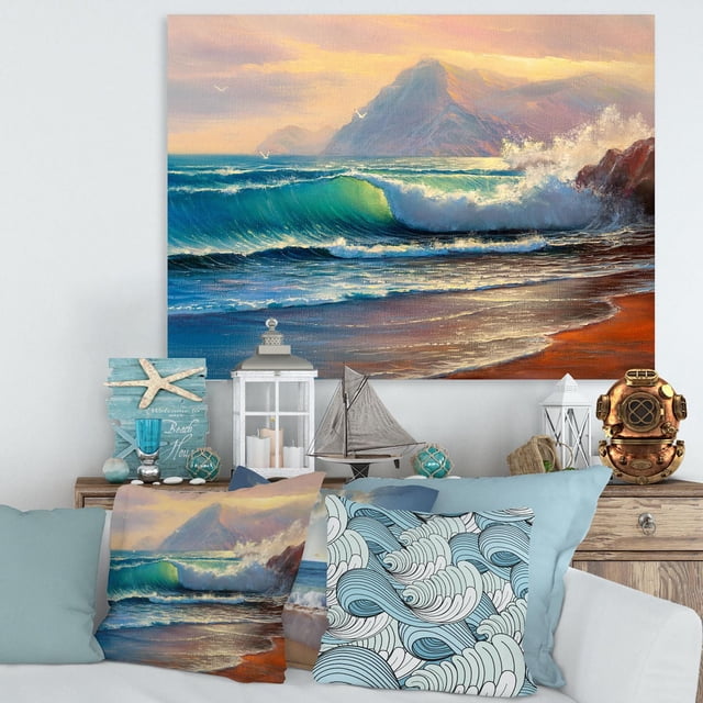 Designart Morning Sunlight On The Sea Waves III Canvas Wall Art depicts a gallery-wrapped cotton canvas print of turquoise waves crashing on a sandy beach at sunrise with distant mountains and seagulls, displayed above a coastal-themed living room with matching pillows and nautical decor, ready to hang.