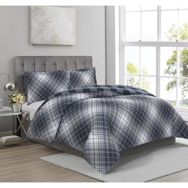 3 Pieces Comforter Set Bias Plaid Dust Blue on a bed with a grey tufted headboard in a bright bedroom. The reversible comforter and two pillow shams feature a blue and grey plaid pattern. Made from 100% microfiber with hypoallergenic down alternative filling, it provides lightweight warmth and is machine washable. The room has light wood flooring, a white rug, a mirrored side table with a lamp and flowers, and large windows showing trees outside. This comforter set is also suitable for adding cozy style to guest rooms.