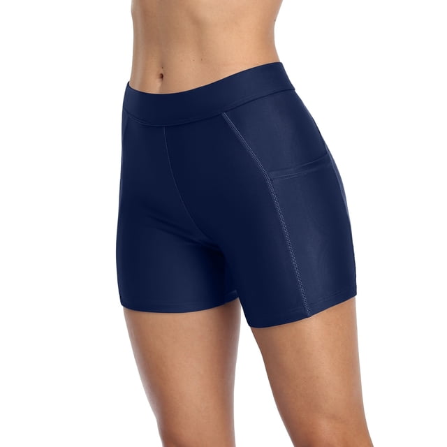 Shorts de Planche Longs pour Femmes avec Poches, Bas de Maillot Unis, Maillots de Bain de Couleur Marine Unie. Présente un design Taille Haute pour une Coupe Flatteuse, Tissu Extensible et Léger Fait de 82 % nylon et 18 % Élasthanne, et une Couverture Style Shorty. Comprend des Poches Latérales Fonctionnelles pour de Petits Articles comme des Clés Ou des Téléphones. Fabriqué avec un Tissu à Séchage Rapide et une protection Solaire UPF, Idéal pour la Natation, la Randonnée, le Vélo et Autres Activités.