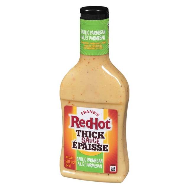 Frank's RedHot Thick Garlic Parmesan Sauce bottle with creamy beige sauce speckled with herbs, featuring a black cap and a label highlighting punchy garlic and salty Parmesan, suitable for use as a marinade, dipping sauce, or cooking sauce.