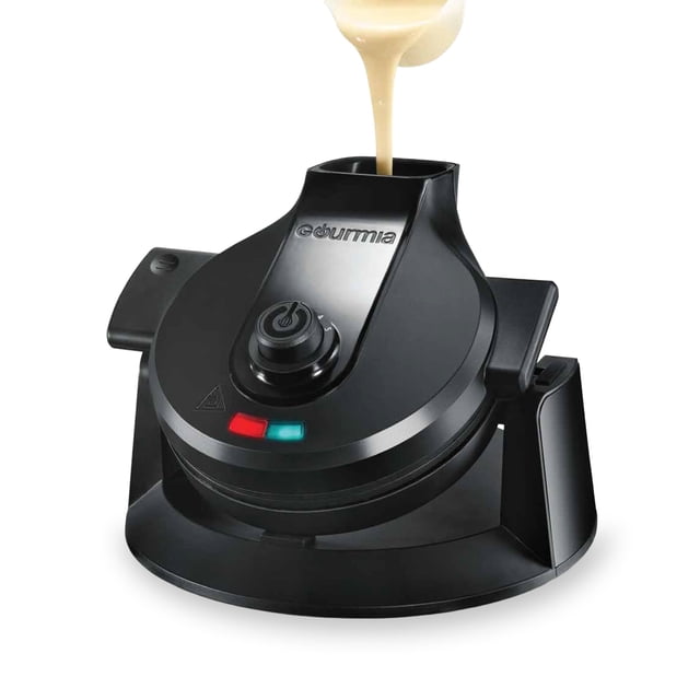 Gourmia Dual Pour Belgian Waffle Maker in black with an easy pour spout for batter, shown in use with batter being poured into the spout. Features a compact design, five browning settings, and indicator lights for preheat and ready status. Nonstick plates and a spill tray ensure easy cleanup.