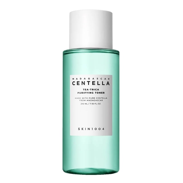 SKIN1004 Madagascar Centella Tea-Trica Purifying Toner 210ml in a transparent green bottle with a white cap and minimalist label design. This face toner is enriched with cypress water, pine leaf extract, and tea tree leaf extract to revitalize oily, acne-prone skin, leaving it soft and balanced.