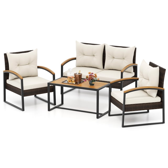 Gymax Set Of 4 Patio Conversation Set with Coffee Table featuring mix brown PE rattan construction, solid acacia wood armrests and tabletop, and off-white cushions. Includes two armchairs, one loveseat, and a rectangular coffee table. Designed with a sturdy metal frame, ergonomic curved armrests, and soft, removable cushions for comfort. Suitable for outdoor use in backyards, balconies, or poolside settings.