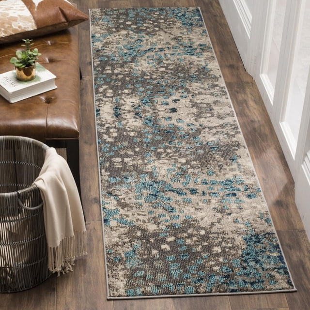 Safavieh Monaco Driskoll Abstract Area Rug runner made of durable power-loomed polypropylene with mixed high and low loop pile, showing a muted abstract pattern in beige, grey, and blue. Placed on dark wood flooring beside a leather bench and woven basket, it suits country or city homes and is ideal as an accent rug for entryways or hallways.