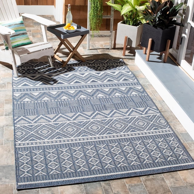SAFAVIEH Bermuda Jacinth Tapis Géométrique Lavable à la Machine pour Intérieur/extérieur sur un patio Extérieur Carrelé avec une Chaise Adirondack Blanche et une table d'Appoint en Bois Tenant une Bouteille et des Citrons. le Tapis à Motif Géométrique Bleu et Blanc Présente un Tissage Texturé et Est Résistant aux Intempéries et aux Taches, Idéal pour Terrasses, Vérandas Ou lanais.