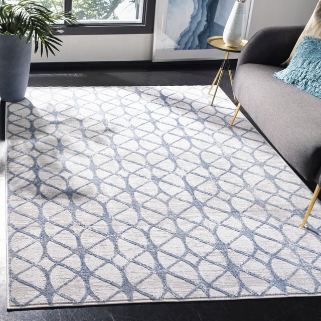 Safavieh Amelia Floella Tapis Géométrique pour Aire avec une texture Pelucheuse et un Motif Géométrique Bleu Contemporain sur un Fond Clair, Placé dans un Salon Moderne Comprenant un sofa Gris avec un Oreiller Bleu, une table d'Appoint à Pattes Dorées et une Grande Plante en Pot Près d'Une Fenêtre, Convient pour Rehausser les Espaces d'Accent.
