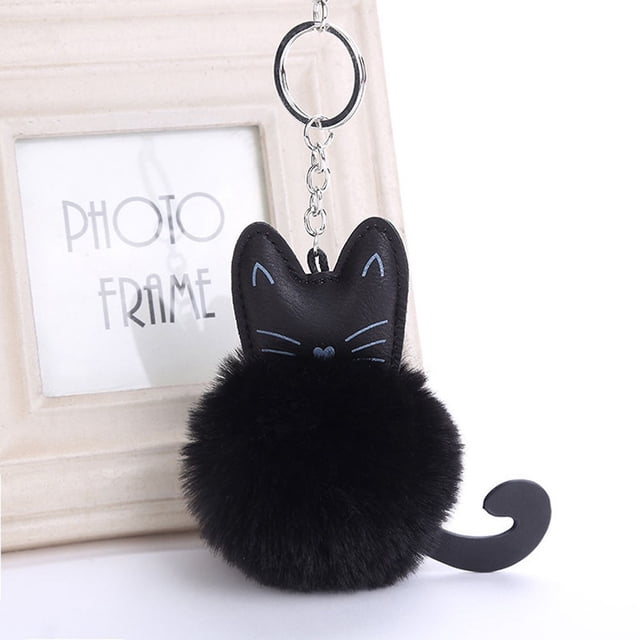 TopLLC Keychains Artificial Key Chain Key Handbag Car Pendant Fashion Creative Keychain featuring a black faux leather cat-shaped design with embroidered blue facial details and a soft, fluffy pom-pom body. The keychain includes a durable silver-tone metal ring and chain, suitable for use as a bag charm, car accessory, or daily key organizer. Measures approximately 18 cm by 8 cm. Displayed against a neutral background with a photo frame.
