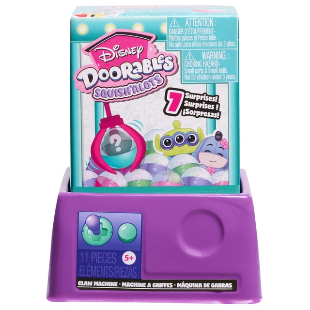 Disney Doorables Whatcha Gotcha Claw Machine collectible toy with a purple plastic base featuring a joystick and button, topped by a colorful box showing Disney Doorables Squish'Alots branding and cartoon characters, designed for kids ages 5 and up, offering 7 surprise capsules as a novelty surprise toy.