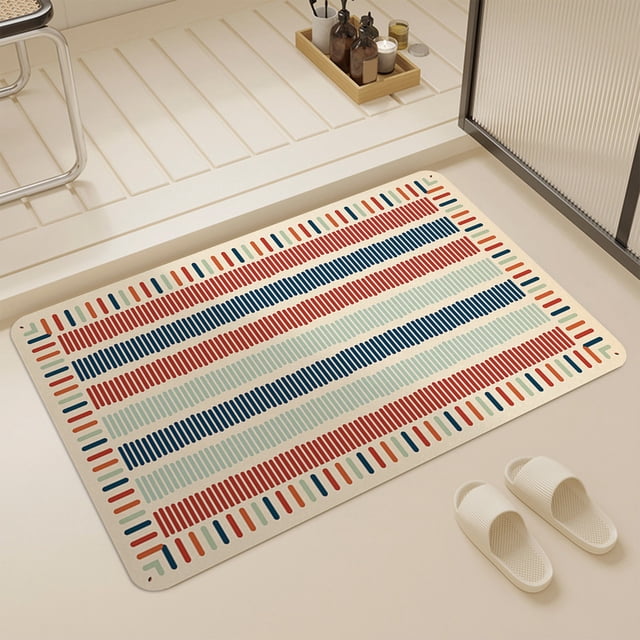 Vaidha absorbent bathroom bath mat with a quick-drying design, shown in a multicolour striped pattern featuring red, blue, and green accents on a beige background. The mat measures 40x60cm and is placed on a bathroom floor near a shower area. It features a non-slip textured bottom for added stability and is suitable for use in bathrooms, kitchens, or as an entrance doormat. White slippers are positioned nearby, emphasizing its use as a comfortable and functional floormat.
