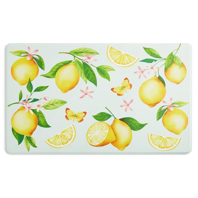 Mainstays Printed Lemons Kitchen Mat, Multi, 18"W x 30"L, 1 Piece front-facing rectangular 18 by 30 inch kitchen mat with repeating lemon print on multicolour printed fabric. Low-profile cushioning noted in product specs and non-slip backing visible at one corner; placed on a hard floor near a sink to suit prep and sink areas and often used as a comfort mat for standing while cooking or doing dishes.