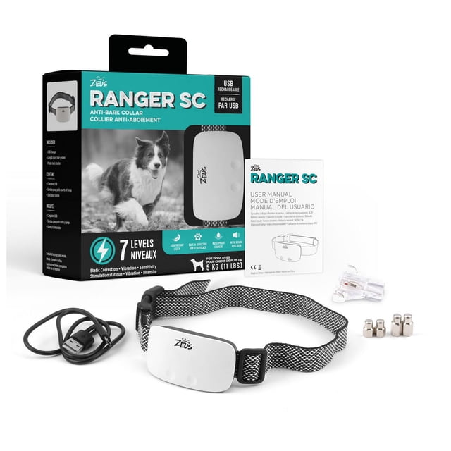 Zeus Ranger SC Anti-Bark Collar featuring a white rectangular device with Zeus logo on an adjustable black and white mesh strap, shown with a USB charging cable, four metal contact probes, a small screwdriver, and user manual, all displayed in front of the product box highlighting 7 levels of static correction, vibration, and sensitivity for dogs over 5 kg (11 lbs).